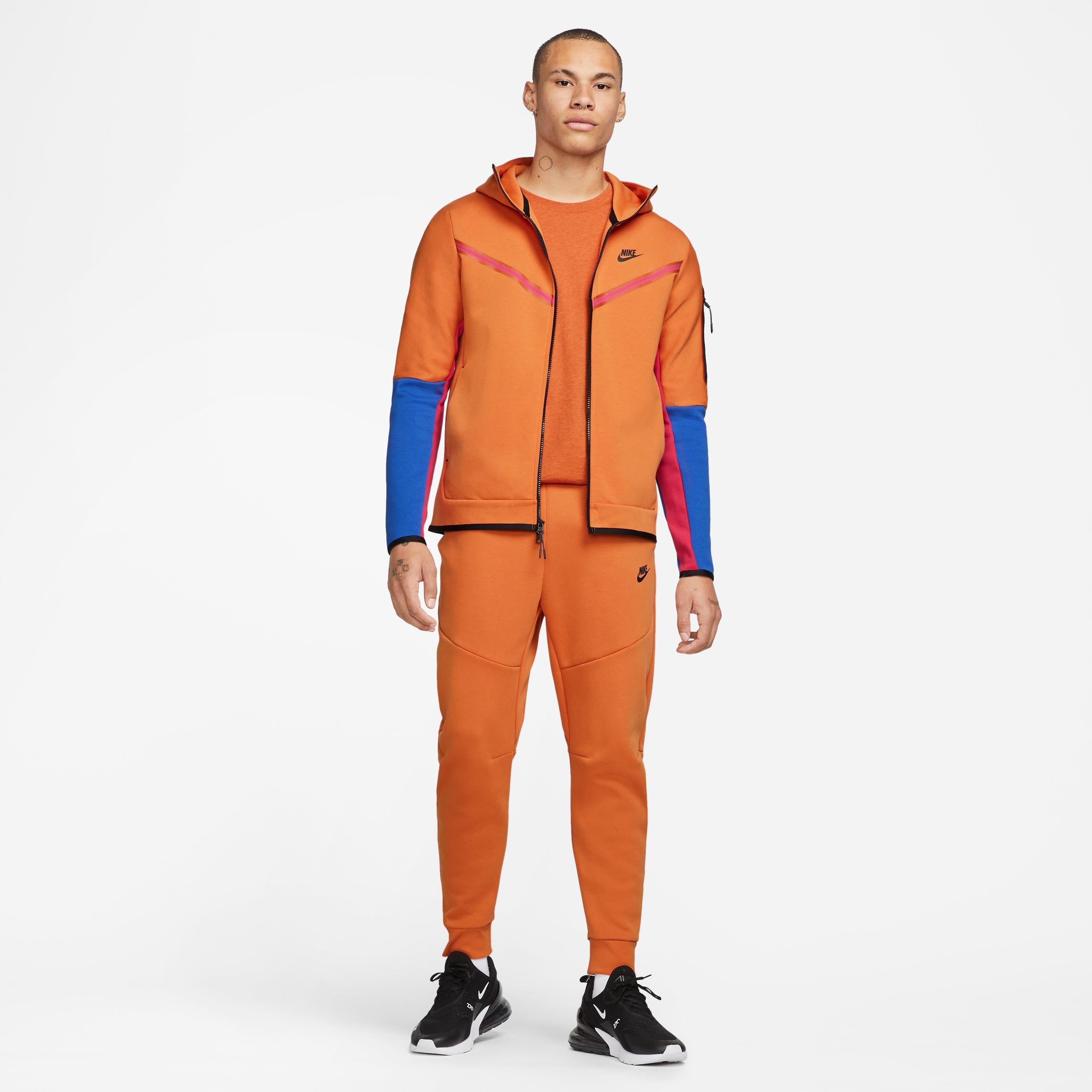 Orange nike hot sale tech tracksuit